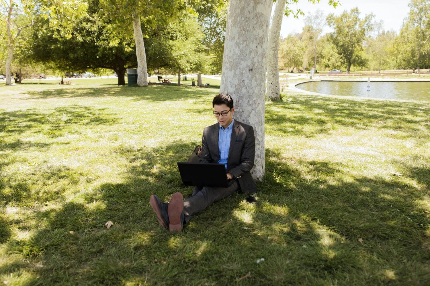 business man sitting on the grass