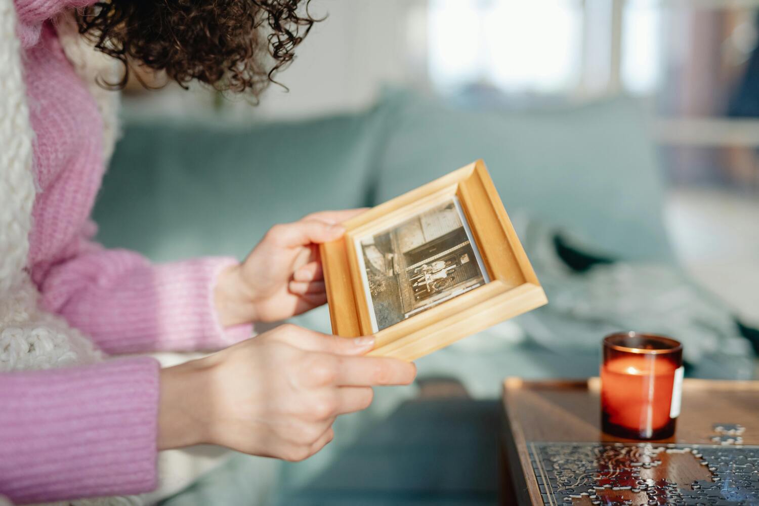 woman looking at framed photo