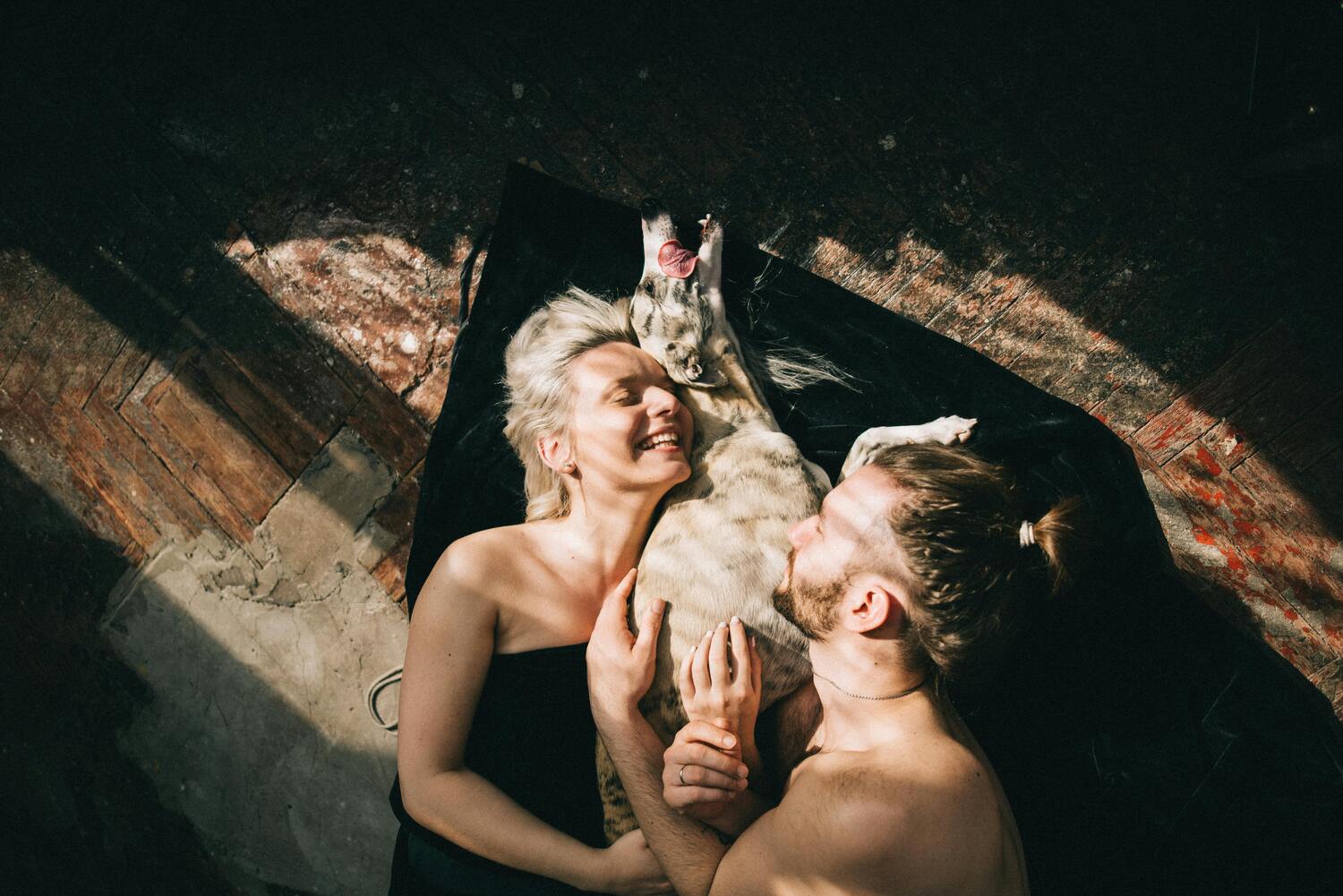 couple in bed with dog